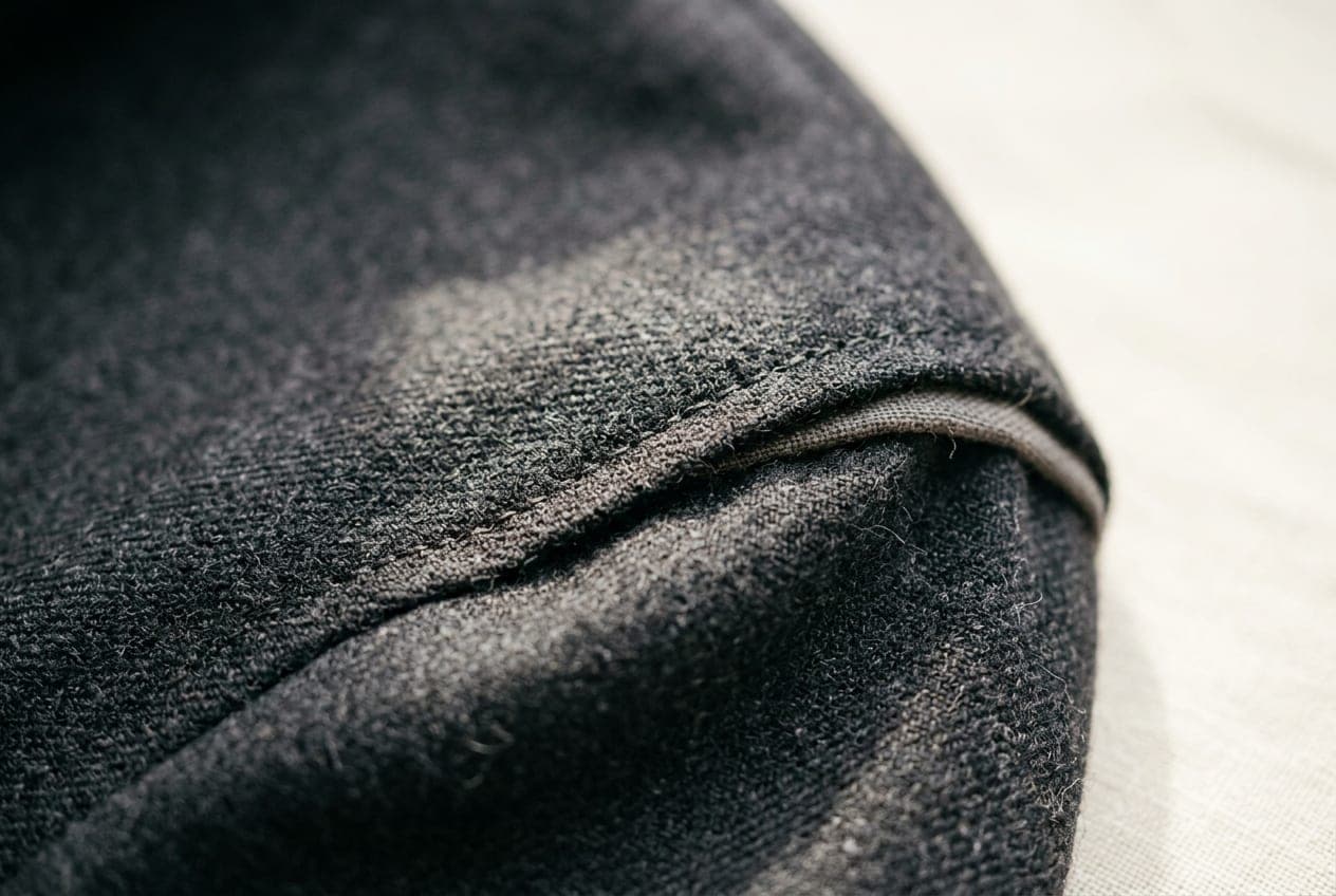 A macro of a tailored shoulder — the sleevehead seam, pick stitching and canvas roll