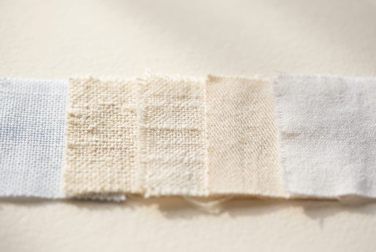 A macro row of five white cloths — optic, cream, ivory, oyster and chalk